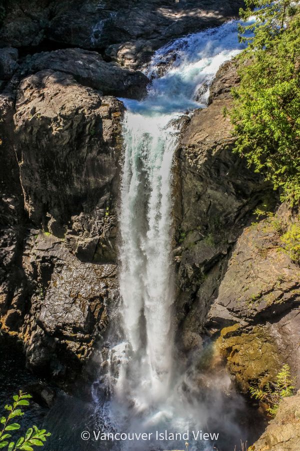 Tall waterfall flowing off a rock bluff into a pool below. This is Elk Falls near Campbell River on Vancouver Island. Vancouver Island View