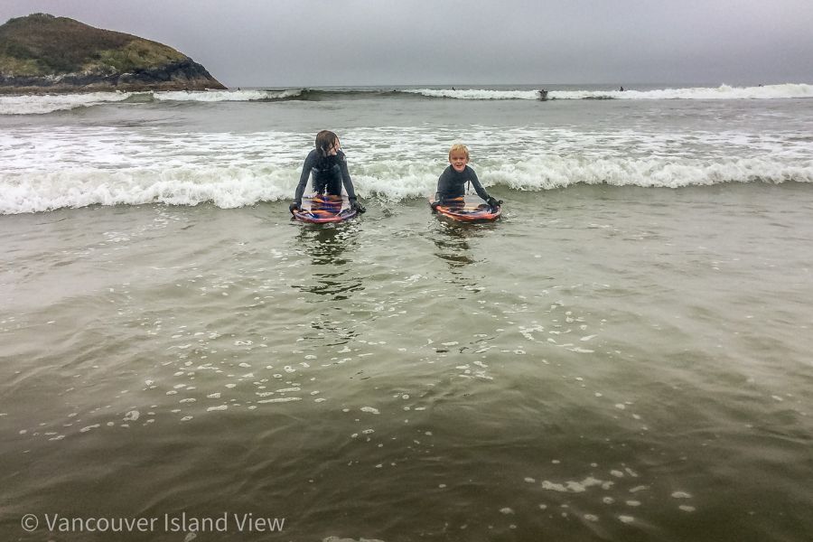 Kids surfing on Long Beach in Tofino. Vancouver Island View