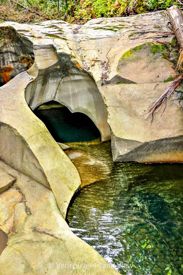 A crystal clear deep water pool inside a uniquely carved smooth rockbed. This is the Cumberland Potholes found near Cumberland, BC on Vancouver Island. Vancouver Island View